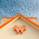 Whataburger sign in front of blue sky with light clouds